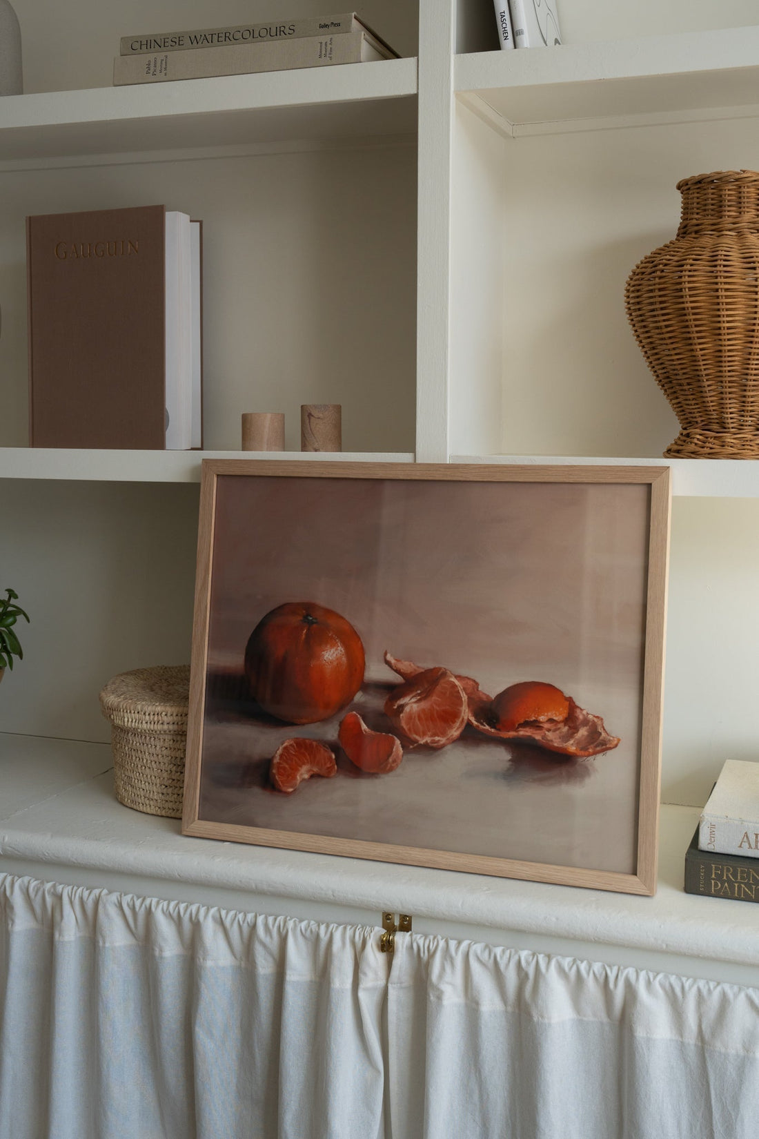 "Clementines" Art print in a natural wood frame, on a shelf.