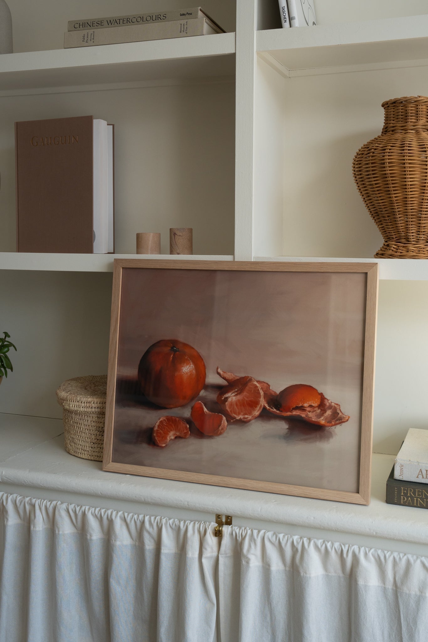 "Clementines" Art print in a natural wood frame, on a shelf.