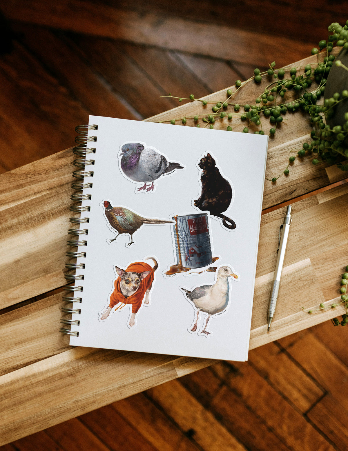 A scattered pile of die-cut vinyl animal stickers by The Ugly Cat Studio